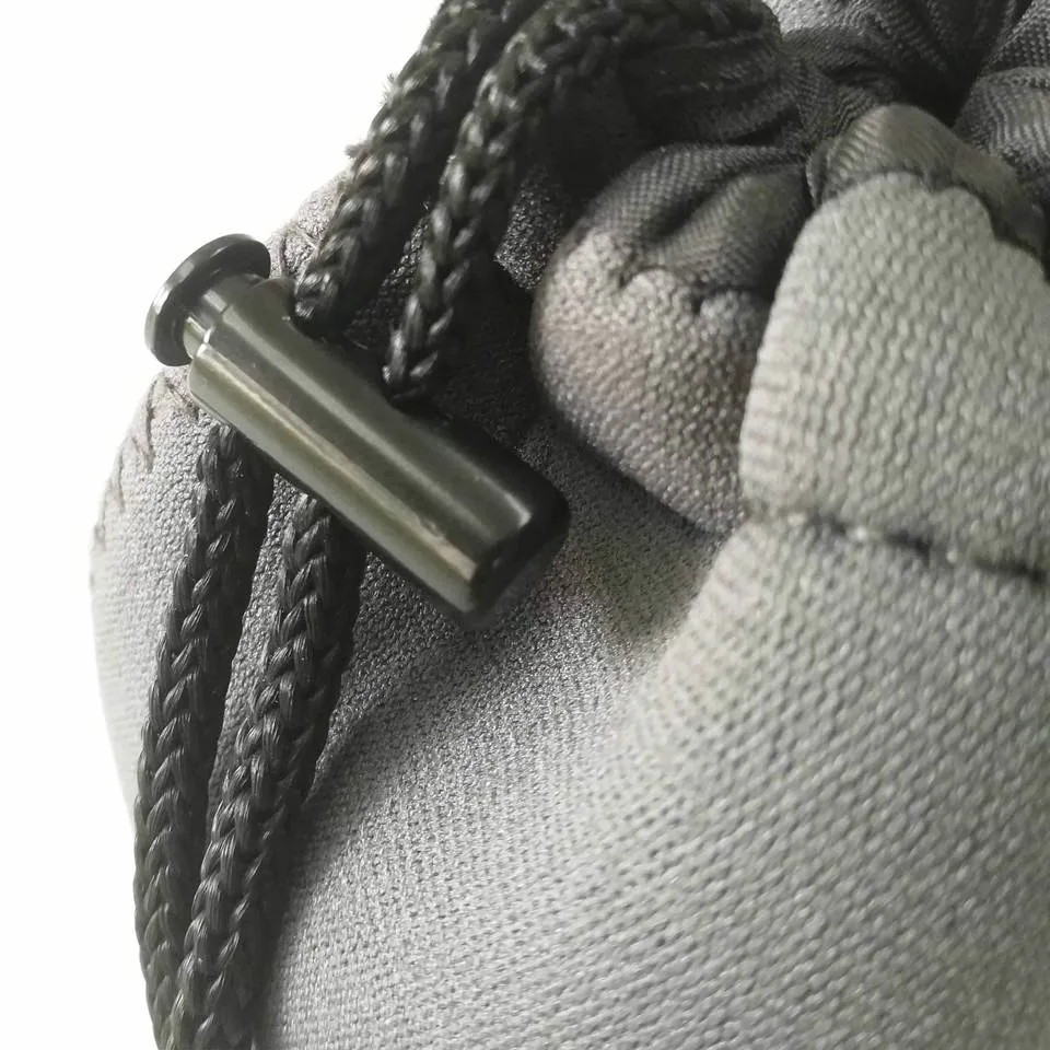 Drawstring cord and sliding lock on the gray lens pouch