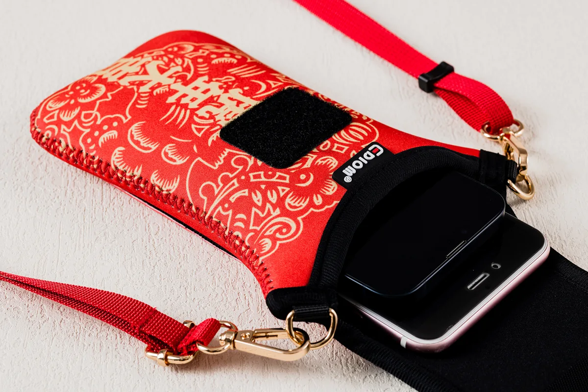 Open red phone pouch with an example phone and detached strap