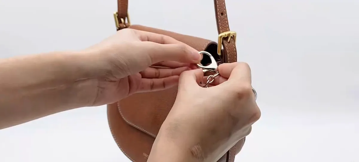 Actual video still showing the holder clip attached to a bag