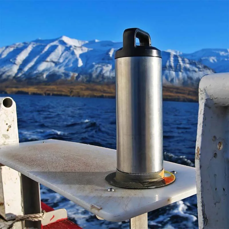 Source photo of a metal bottle standing in a ring on an outdoor seat
